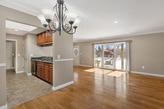 kitchen featuring a skylight, a sink, light wood-type flooring, brown cabinets, and dishwasher