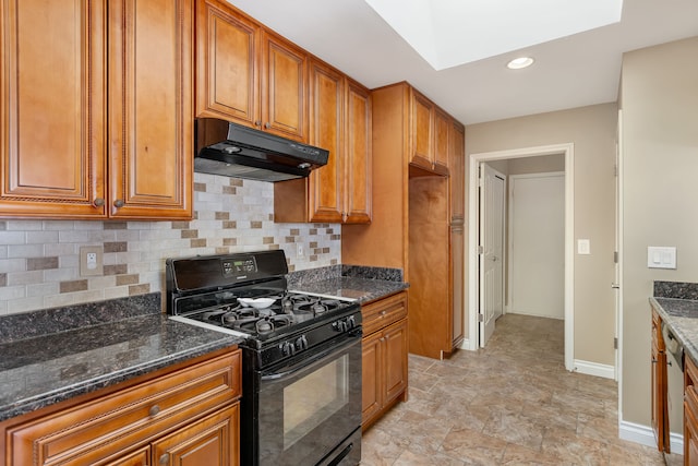 kitchen featuring black gas range oven, under cabinet range hood, and brown cabinets