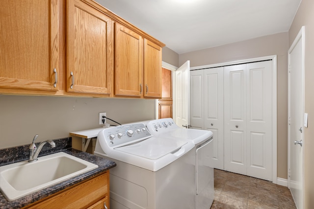 laundry area with cabinet space, a sink, and separate washer and dryer