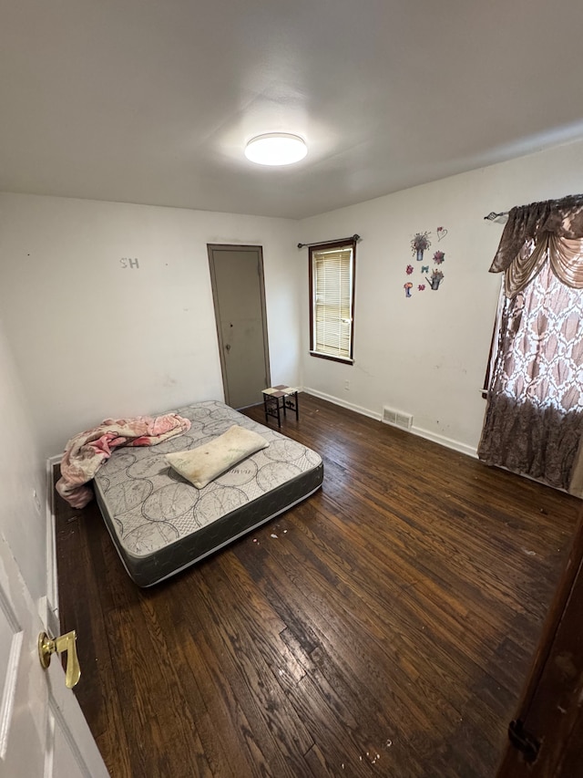 bedroom featuring dark wood-type flooring