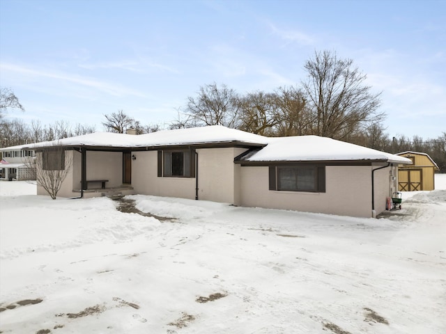 view of snow covered rear of property