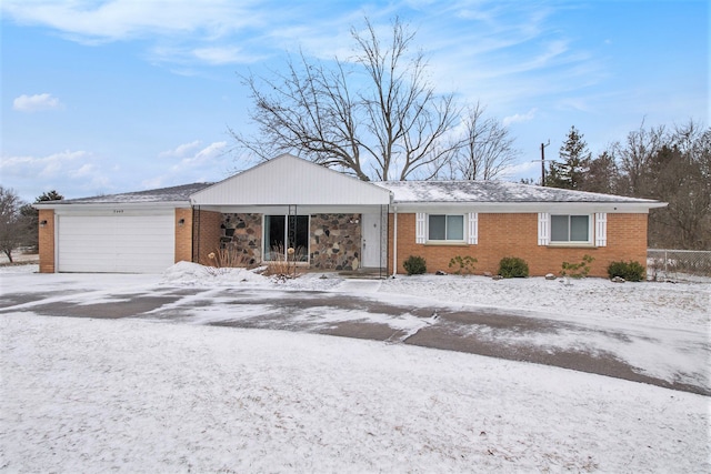 ranch-style home with a garage, brick siding, and fence