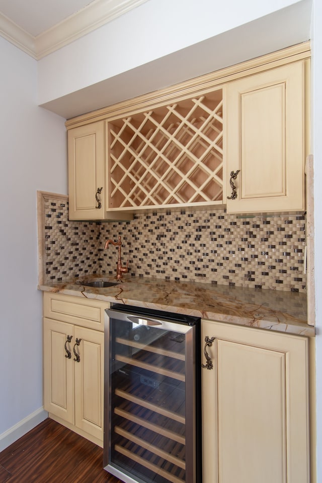 bar featuring crown molding, wine cooler, tasteful backsplash, and indoor wet bar