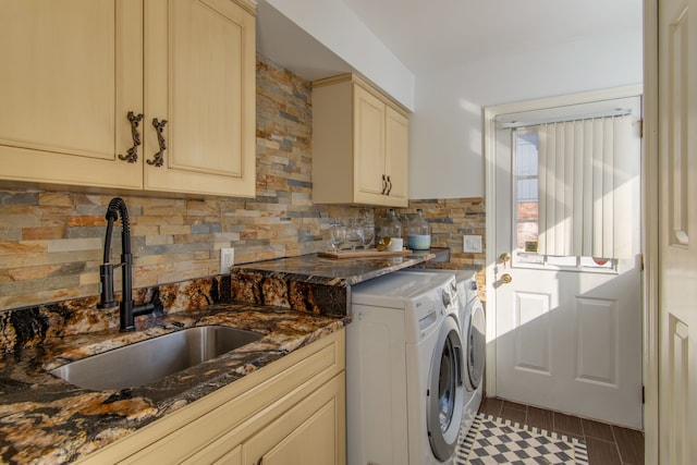 laundry area featuring cabinet space, a sink, washing machine and clothes dryer, and wood finished floors