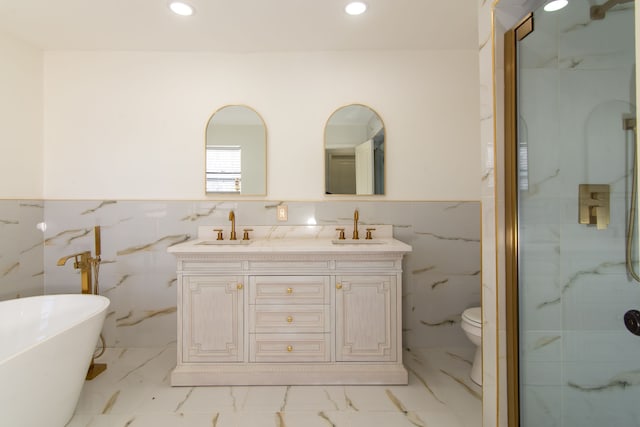 bathroom with a soaking tub, recessed lighting, marble finish floor, and a sink