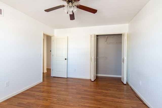 unfurnished bedroom with a ceiling fan, a closet, dark wood finished floors, and baseboards