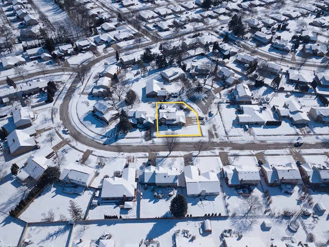 snowy aerial view with a residential view