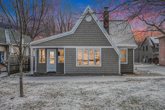 view of back house at dusk