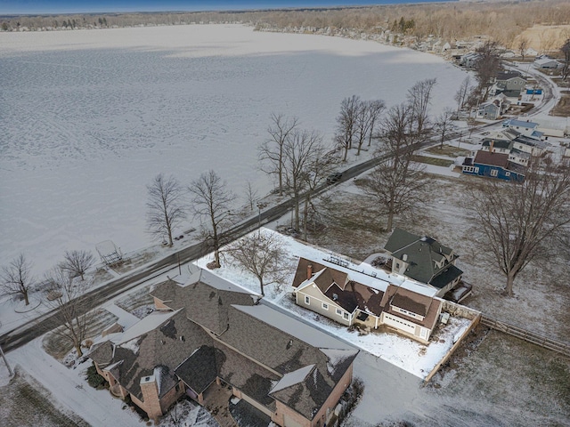 snowy aerial view featuring a water view