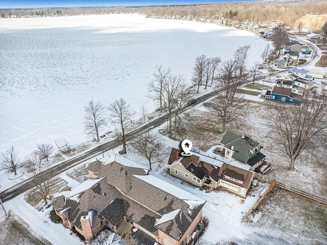 snowy aerial view featuring a water view