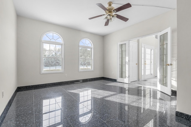 unfurnished room featuring ceiling fan and french doors