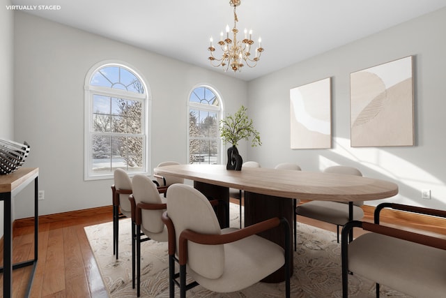 dining area featuring a chandelier and light wood-type flooring