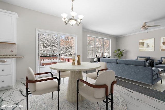 dining area with ornamental molding and ceiling fan with notable chandelier