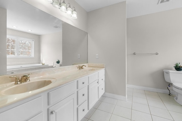 bathroom featuring vanity, tile patterned floors, a tub, and toilet