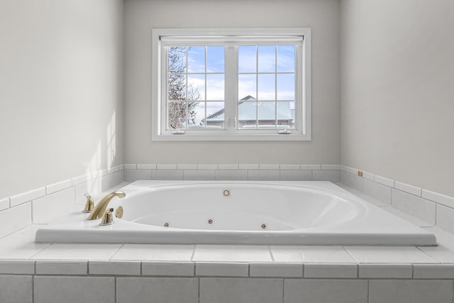 bathroom with a relaxing tiled tub