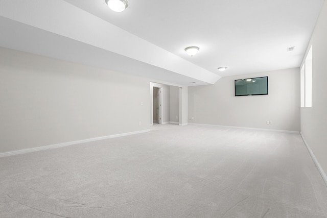 unfurnished room featuring lofted ceiling and carpet flooring