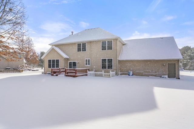 view of snow covered rear of property