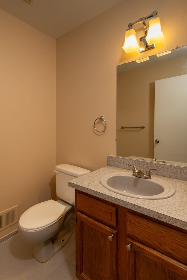 bathroom featuring toilet, tile patterned floors, visible vents, and vanity