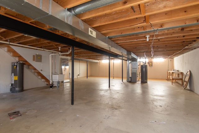 unfinished basement featuring gas water heater, visible vents, heating unit, and stairs