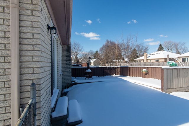 snowy yard with fence