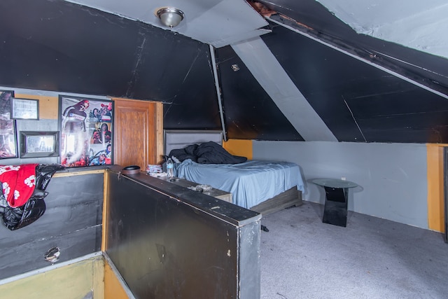 carpeted bedroom with vaulted ceiling