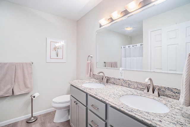 bathroom with vanity, hardwood / wood-style floors, and toilet