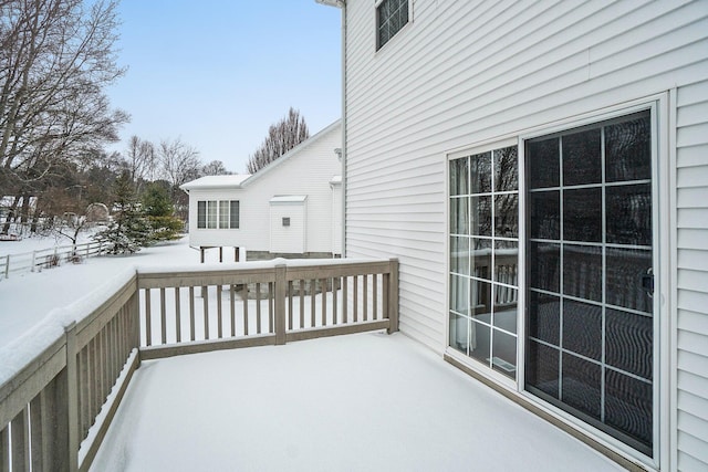 view of snow covered back of property