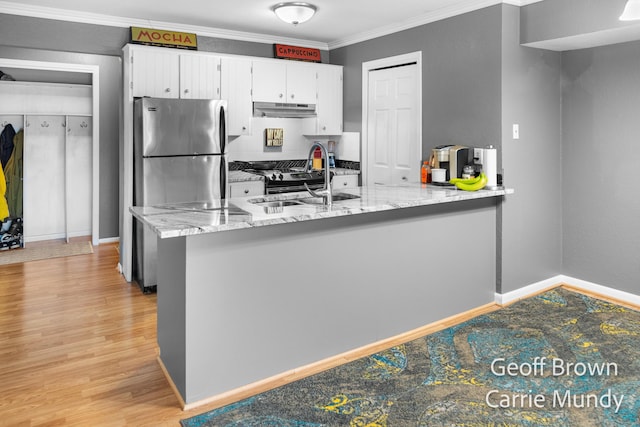 kitchen with crown molding, light hardwood / wood-style flooring, white cabinetry, light stone counters, and kitchen peninsula