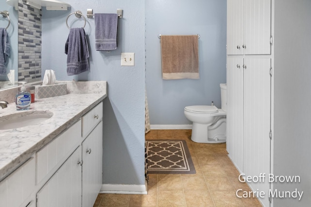 bathroom with vanity, tile patterned flooring, and toilet