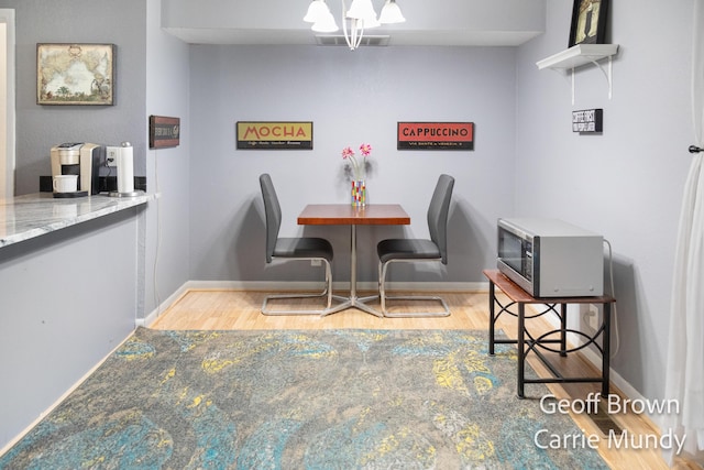 dining space with an inviting chandelier and light wood-type flooring