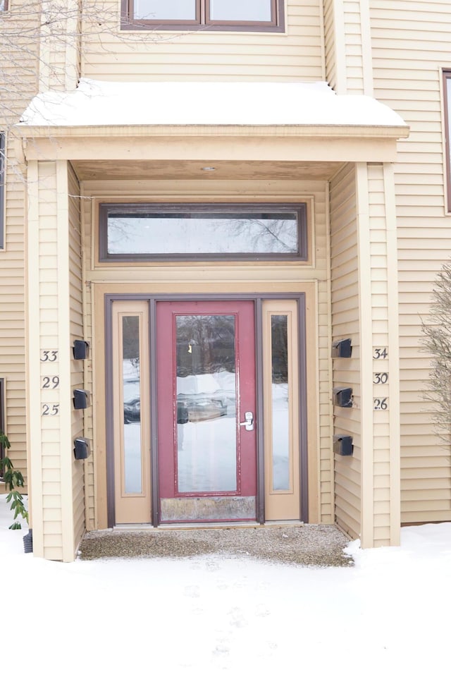 view of snow covered property entrance