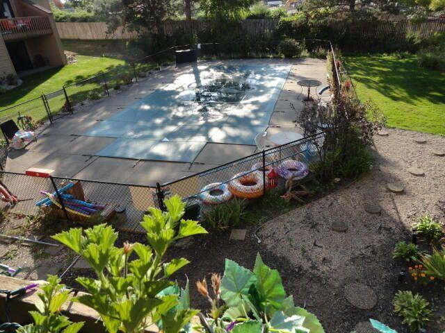 view of swimming pool featuring a diving board, a patio area, and a lawn