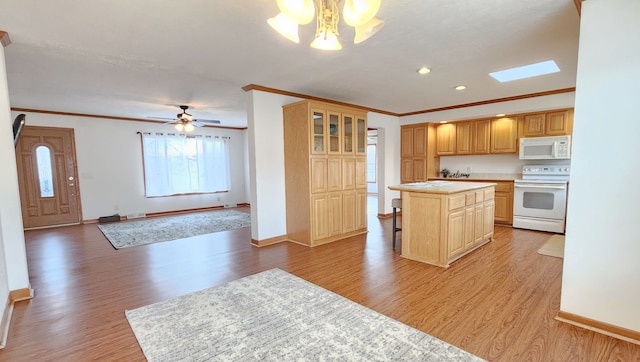 kitchen featuring white appliances, a kitchen island, light wood-style flooring, light countertops, and open floor plan