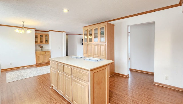 kitchen featuring light wood-style floors, ornamental molding, and light brown cabinets