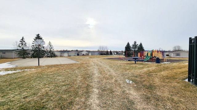 view of yard featuring playground community and community basketball court