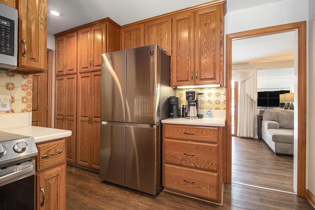 kitchen featuring brown cabinets, stainless steel appliances, and light countertops