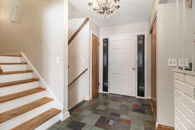 entrance foyer with an inviting chandelier, stone finish flooring, stairway, and baseboards