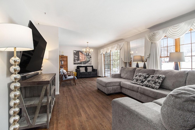 living room featuring dark wood finished floors and an inviting chandelier