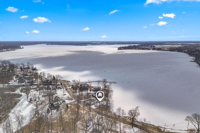 snowy aerial view featuring a water view