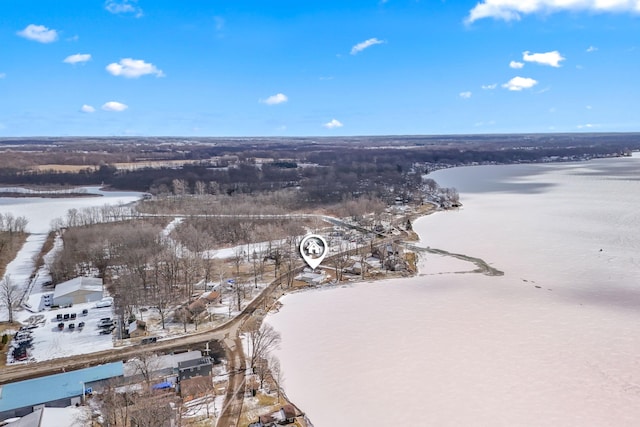 snowy aerial view with a water view