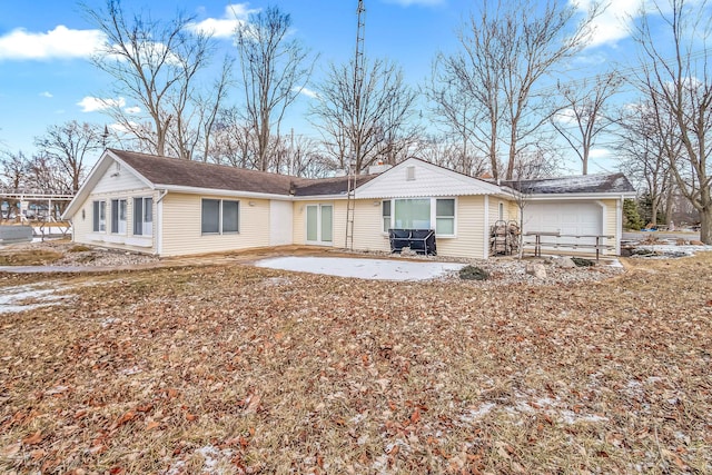 back of property with a garage