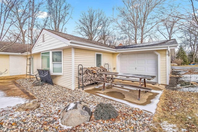 view of snowy exterior with a garage