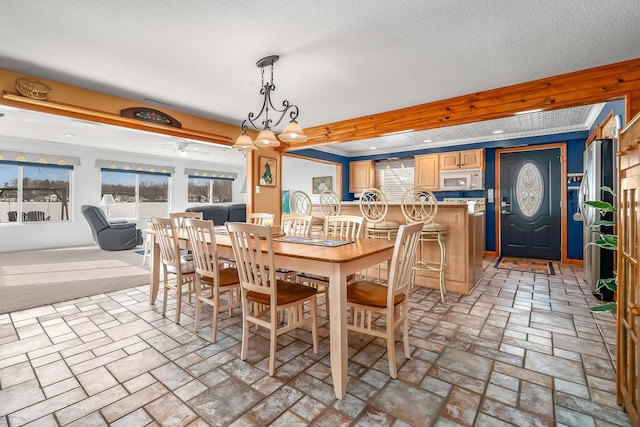 dining area featuring a textured ceiling