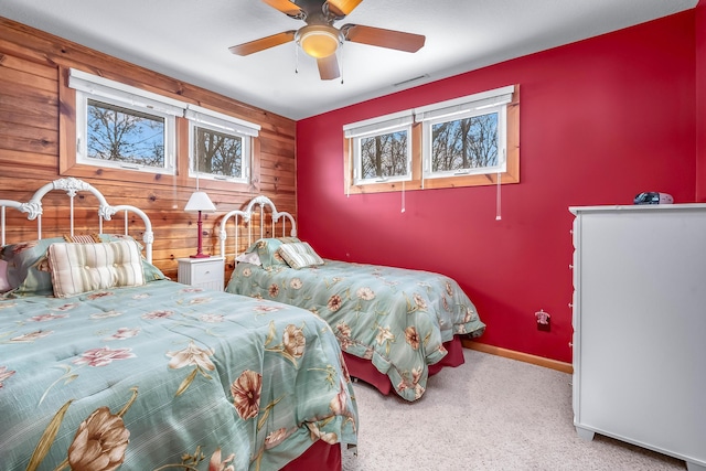 bedroom with wooden walls and ceiling fan