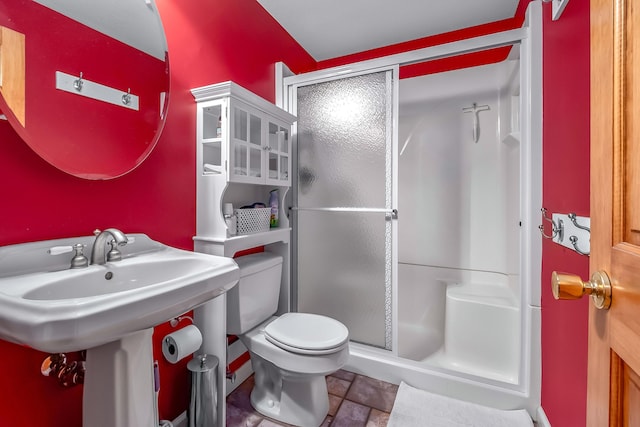 bathroom with toilet and an enclosed shower