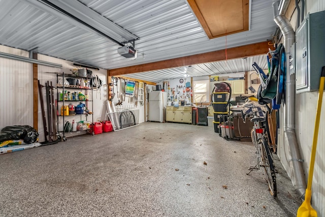 garage featuring a garage door opener and white fridge