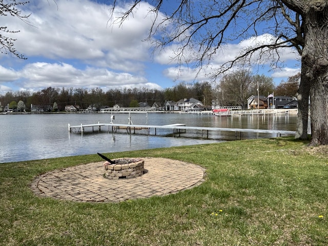 509 Warren Rd, Coldwater, MI 49036 - view of green lawn with a boat dock, an outdoor fire pit, and a water view