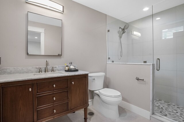 bathroom featuring a stall shower, vanity, and toilet