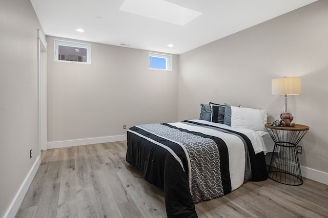 bedroom featuring recessed lighting, light wood-style flooring, and baseboards