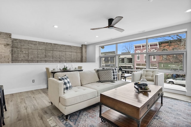 living area with ceiling fan, recessed lighting, wood finished floors, and baseboards